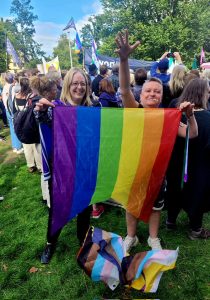 Author Helen Joyce poses proudly with a vandalised pride flag in 2022